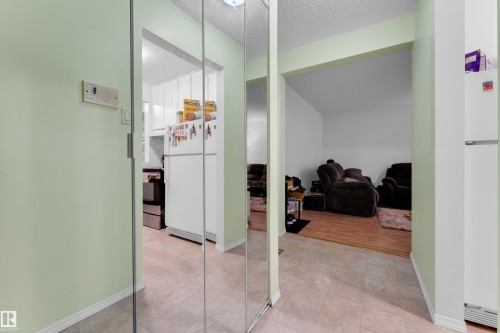 Mirrored closet doors providing a bright aesthetic - #104 11445 41 Av Nw, Edmonton, AB - Indoor Photo Showing Other Room
