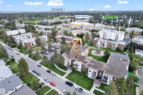 Aerial perspective showcasing the residential complex with surrounding green spaces and established trees - #104 11445 41 Av Nw, Edmonton, AB - Outdoor With View