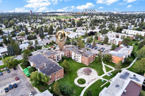 Aerial perspective of a multi-building apartment complex featuring brick facades and multiple balconies - #104 11445 41 Av Nw, Edmonton, AB - Outdoor With View