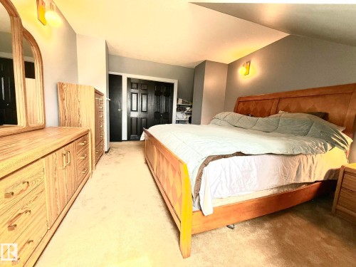 Bedroom featuring neutral carpeting and light gray wall paint - 4508 57 Avenue, Lamont, AB - Indoor Photo Showing Bedroom