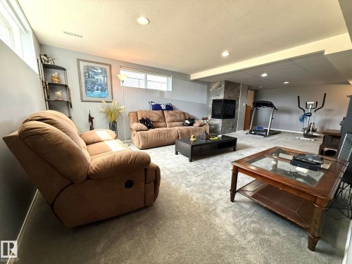 Spacious finished basement featuring a generous recreation area with neutral carpet flooring, recessed ceiling lighting, and ample square footage - 4508 57 Avenue, Lamont, AB - Indoor