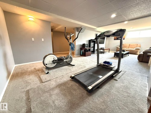 Spacious lower level featuring plush carpeting, recessed lighting, and a drop ceiling - 4508 57 Avenue, Lamont, AB - Indoor Photo Showing Gym Room