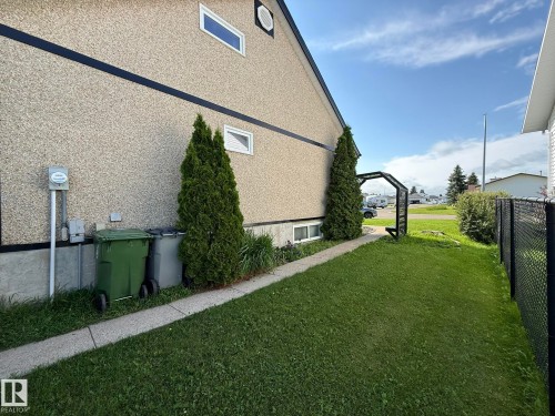Stucco exterior with black trim accents and a pitched roofline - 4508 57 Avenue, Lamont, AB - Outdoor