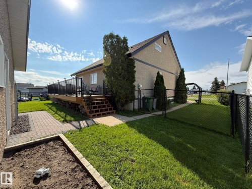 Expansive outdoor deck with dark railing and stairs - 4508 57 Avenue, Lamont, AB - Outdoor With Deck Patio Veranda