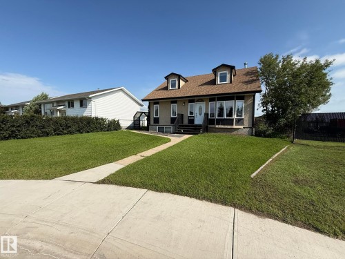 Two-story residence featuring a brown shingle roof with two dormer windows - 4508 57 Avenue, Lamont, AB - Outdoor With Deck Patio Veranda With Facade