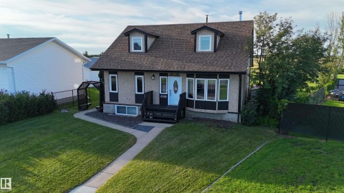 Two-story residence featuring a shingled roof and stucco exterior - 4508 57 Avenue, Lamont, AB - Outdoor
