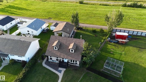 Front exterior featuring a dormered roof, bay window, and a pathway leading to the entrance - 4508 57 Avenue, Lamont, AB - Outdoor