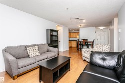 Open concept living area featuring wood-finish flooring - 