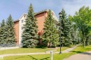 Multi-story building featuring a brown and cream facade, multiple windows, and a curved balcony railing - #106 12110 106 Av Nw, Edmonton, AB  - Outdoor 