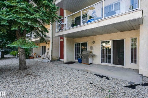 Ground-floor patio with a concrete surface and gravel landscaping - #106 12110 106 Av Nw, Edmonton, AB - Outdoor