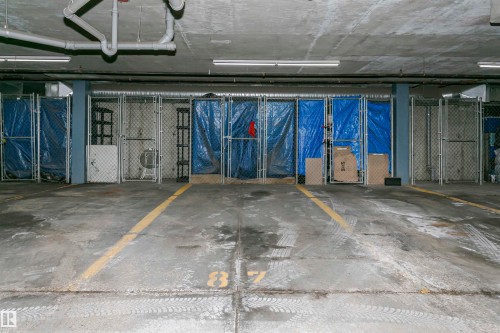 Concrete flooring with painted yellow lines - #106 12110 106 Av Nw, Edmonton, AB - Indoor Photo Showing Garage