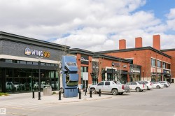 Commercial building showcasing a brick and dark facade with large storefront windows - 
