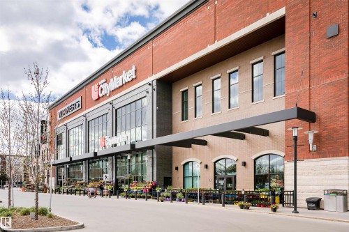 Modern retail building featuring a brick exterior and large storefront windows - #106 12110 106 Av Nw, Edmonton, AB - Outdoor