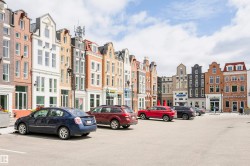 Mixed-use commercial buildings featuring varied architectural styles and materials including brick, stucco, and dark siding - 