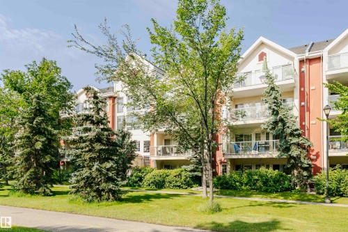 Multi-story residential building with light-colored facade and terracotta accents - #106 12110 106 Av Nw, Edmonton, AB - Outdoor