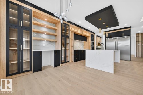 Open-concept kitchen and living area featuring light wood-finish flooring - 427 172 Avenue Nw, Edmonton, AB - Indoor Photo Showing Kitchen