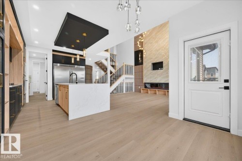 Open-concept living space featuring light wood-finish flooring throughout - 427 172 Avenue Nw, Edmonton, AB - Indoor Photo Showing Kitchen