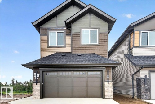 Contemporary two-story exterior featuring a multi-toned facade with horizontal siding and shake shingles - 427 172 Avenue Nw, Edmonton, AB - Outdoor With Exterior