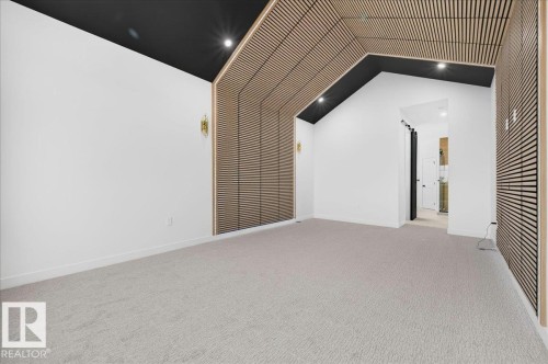Interior space featuring textured wood-paneling accents, white walls, and a black ceiling - 427 172 Avenue Nw, Edmonton, AB - Indoor Photo Showing Other Room
