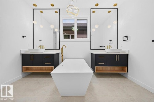 Freestanding soaking tub centered between dual floating vanities - 427 172 Avenue Nw, Edmonton, AB - Indoor