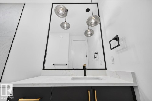 Contemporary vanity featuring a rectangular undermount sink, quartz countertop, and matte black faucet - 427 172 Avenue Nw, Edmonton, AB - Indoor Photo Showing Bathroom