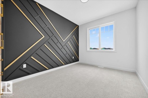 Accent wall featuring a geometric black and gold design - 427 172 Avenue Nw, Edmonton, AB - Indoor Photo Showing Other Room