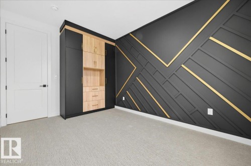 Accent wall featuring geometric paneling with gold-toned inlays - 427 172 Avenue Nw, Edmonton, AB - Indoor Photo Showing Other Room
