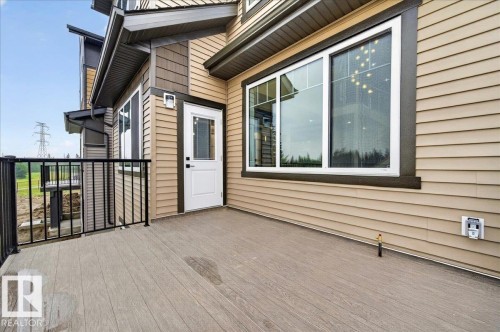 Spacious outdoor deck featuring wood-finish flooring and black metal railings - 427 172 Avenue Nw, Edmonton, AB - Outdoor With Exterior