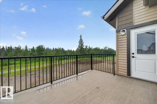 Outdoor balcony featuring composite decking and a black metal railing - 427 172 Avenue Nw, Edmonton, AB - Outdoor With Exterior