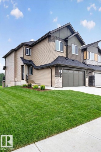 Contemporary multi-level residence featuring a neutral siding exterior with dark trim accents - 427 172 Avenue Nw, Edmonton, AB - Outdoor