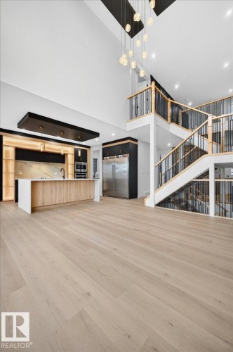Open-concept living area featuring light wood-finish flooring - 427 172 Avenue Nw, Edmonton, AB - Indoor Photo Showing Other Room