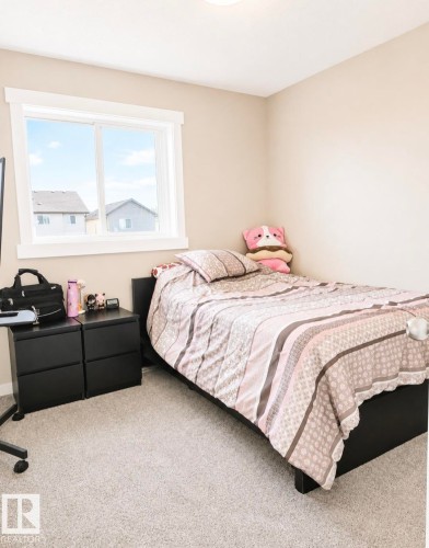 Neutral-toned bedroom featuring light beige walls and a light-colored carpet - 5135 1A Avenue Sw, Edmonton, AB - Indoor Photo Showing Bedroom