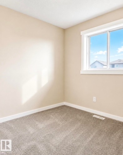 Room featuring neutral-toned walls, white trim, and light gray carpet - 5135 1A Avenue Sw, Edmonton, AB - Indoor Photo Showing Other Room