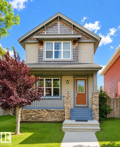 Craftsman-style exterior featuring a prominent gable with shingle siding, tan horizontal siding, and stone accents - 5135 1A Avenue Sw, Edmonton, AB - Outdoor