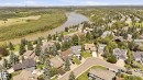 Residential neighborhood featuring a meandering river, mature tree canopy, varied architectural styles, and solar panel installations on select rooftops - 4108 Ramsay Road Nw, Edmonton, AB  - Outdoor With View 