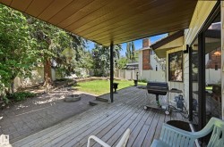 Covered outdoor deck with wood-finish planks - 