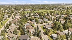 Aerial perspective showcasing a residential area with mature trees and varied architectural styles - 
