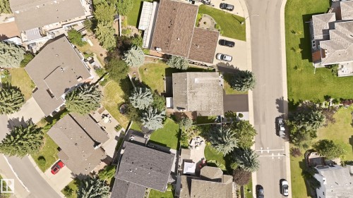 Residential properties featuring shingle roofs, private yards with mature trees, and paved driveways - 4108 Ramsay Road Nw, Edmonton, AB - Outdoor With View