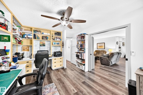 Dedicated office space featuring built-in shelving, integrated desks, and storage drawers - #401 14810 51 Av Nw, Edmonton, AB - Indoor Photo Showing Office
