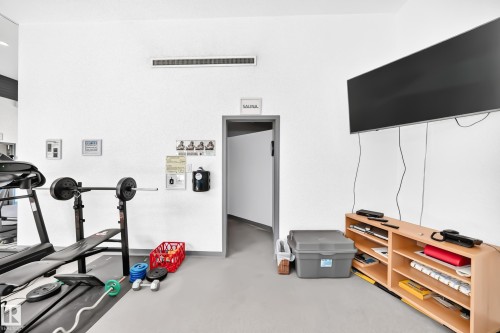 Dedicated fitness area with light gray flooring and white walls - #401 14810 51 Av Nw, Edmonton, AB - Indoor Photo Showing Gym Room