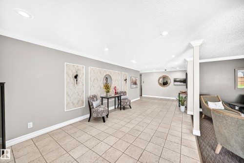 Spacious entryway featuring large format square tile flooring and recessed lighting - #401 14810 51 Av Nw, Edmonton, AB - Indoor Photo Showing Other Room