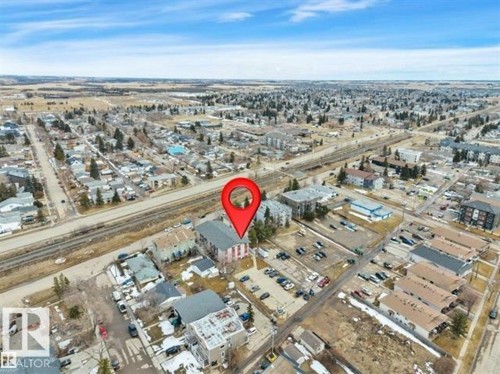 Aerial perspective showcasing a mixed-use neighborhood with residential and commercial properties - #10 4616 47 St, Leduc, AB - Outdoor With View