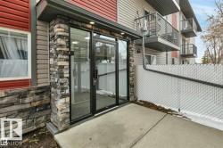Ground floor entry featuring stacked stone accents - 