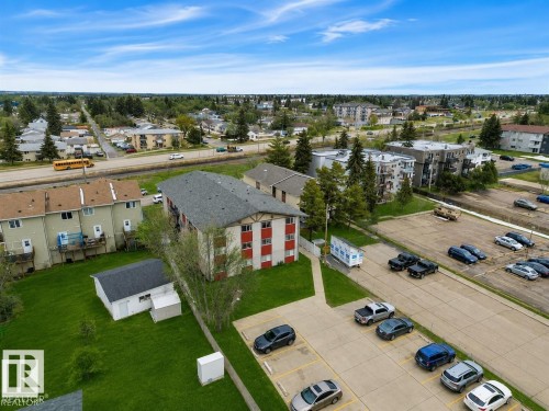Multi-unit building featuring red siding accents and a pitched roof - #10 4616 47 St, Leduc, AB - Outdoor With View