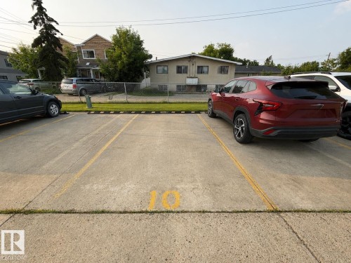 Designated parking space with clear yellow markings and number 10 - #10 4616 47 St, Leduc, AB - Outdoor