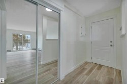 Entryway featuring wood-look flooring and a mirrored closet - 