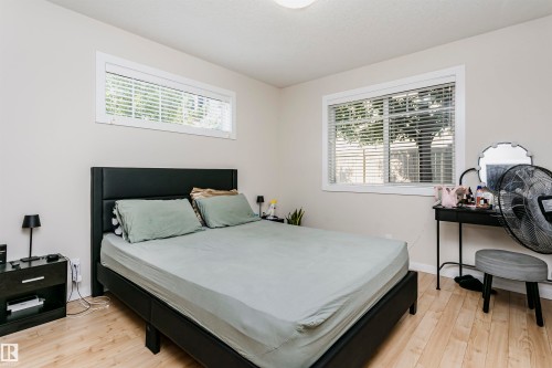 Bedroom featuring light wood-finish flooring and neutral wall tones - #104 9519 160 Av Nw, Edmonton, AB - Indoor Photo Showing Bedroom