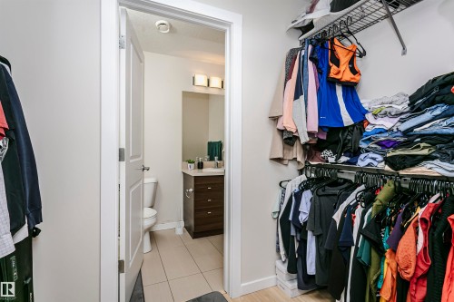 Walk-in closet featuring wire shelving and hanging rods - #104 9519 160 Av Nw, Edmonton, AB - Indoor With Storage