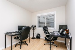 Room featuring neutral wall paint, wood-finish flooring, and a window with horizontal blinds - 