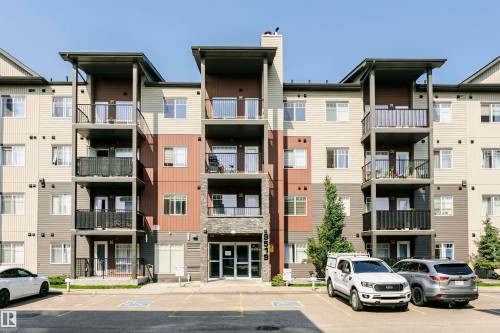 Modern multi-story building featuring a facade of horizontal siding in varying earth tones - #104 9519 160 Av Nw, Edmonton, AB - Outdoor With Facade